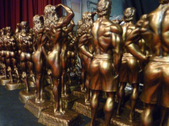 Trophies lined up backstage at an NPC competition, waiting to be awarded to the top five competitors in each height class. Photo by Megan Looney.